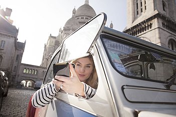 Manequin walking in 2CV Citroën in front of the Sacred Heart