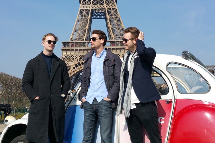 Friends on a 2CV ride in front of the Eiffel Tower